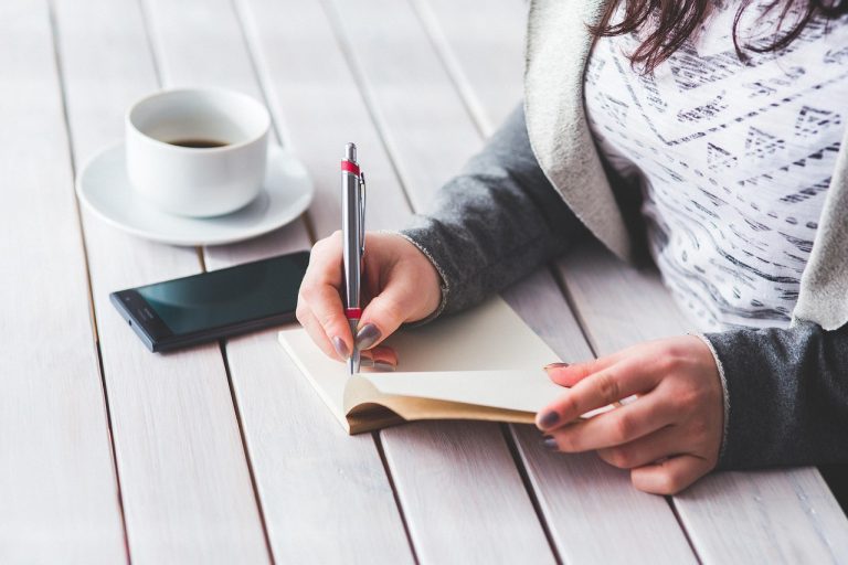 Woman, write, notepad — Living the Dream: A Look Into the Life of an Instagram Mega-Famous Star