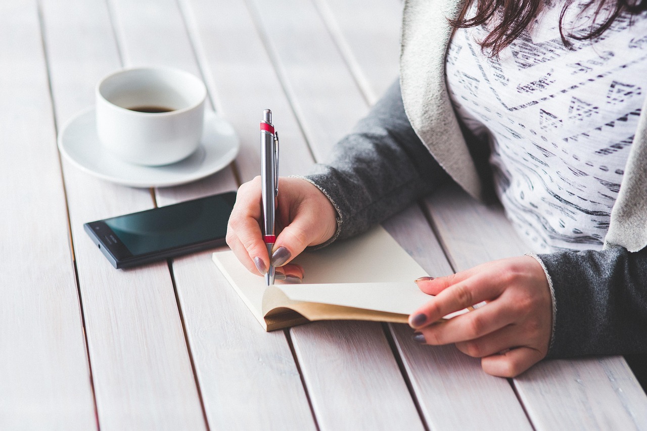 Woman, write, notepad — Living the Dream: A Look Into the Life of an Instagram Mega-Famous Star